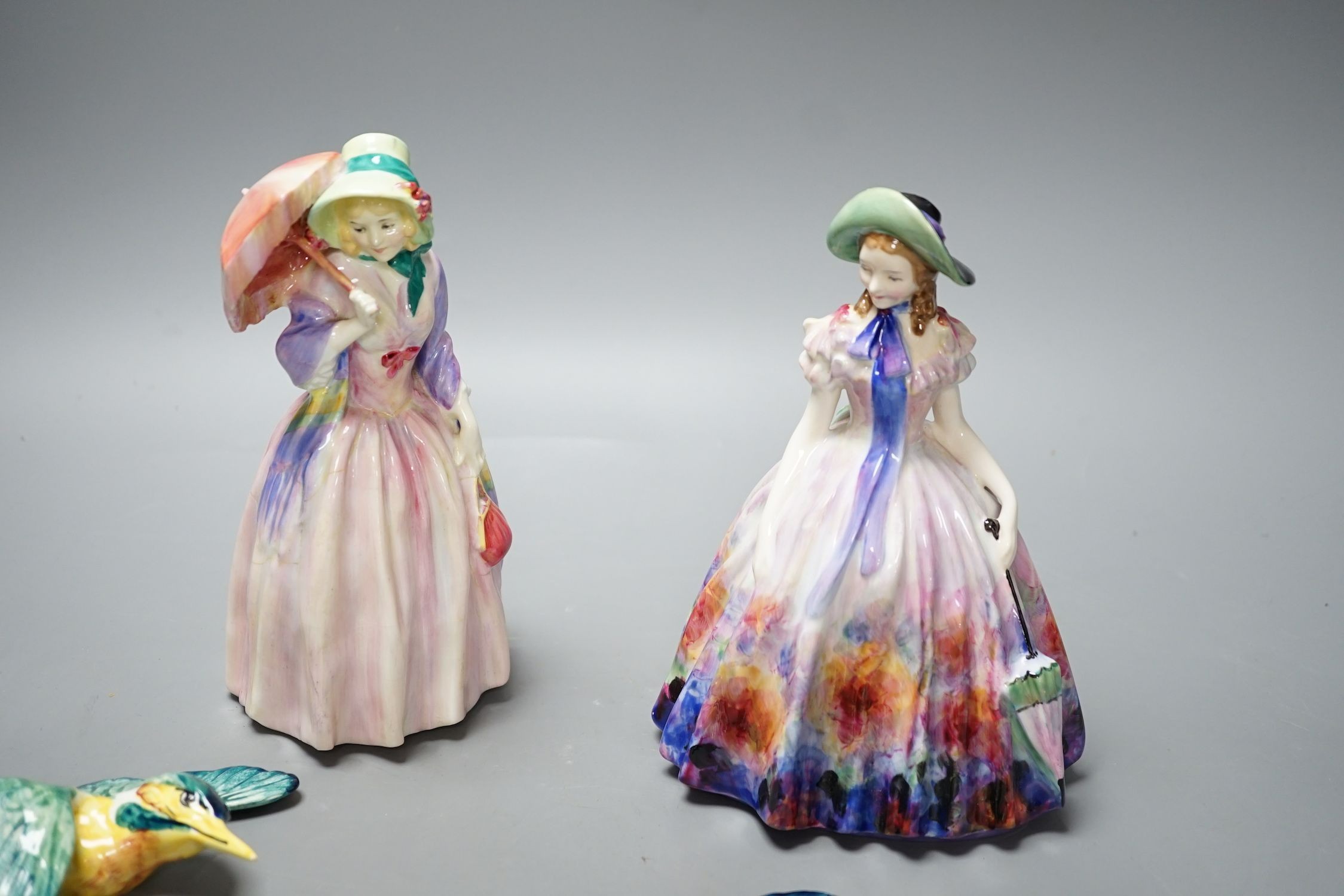 A Royal Doulton figurine: Reg No753474, Miss Demure and an Easter Day figurine: HN 2039, together with three Beswick Kingfisher wall plaques, damage